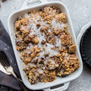 Top view of easy french toast bake in a white casserole dish on a grey background with napkins