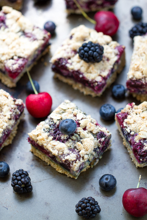 Overhead view of Fresh Cherry Berry Crumble Bars surrounded by berries and cherries