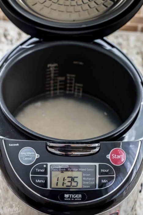 Uncooked rice with water in a rice cooker