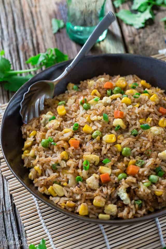 Perfect Fried Rice recipe in a large black bowl with a silver spoon.