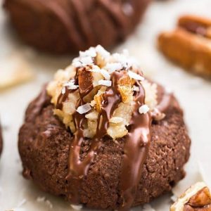 German Chocolate Thumbprint Cookies are all of the things you love about German Chocolate Cake in a cute little thumbprint cookie! A rich, chocolate shortbread with a coconut pecan frosting and drizzled in chocolate!