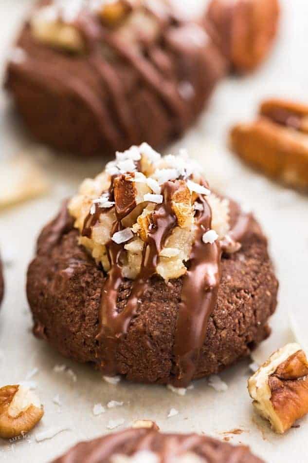 German Chocolate Thumbprint Cookies are all of the things you love about German Chocolate Cake in a cute little thumbprint cookie! A rich, chocolate shortbread with a coconut pecan frosting and drizzled in chocolate!