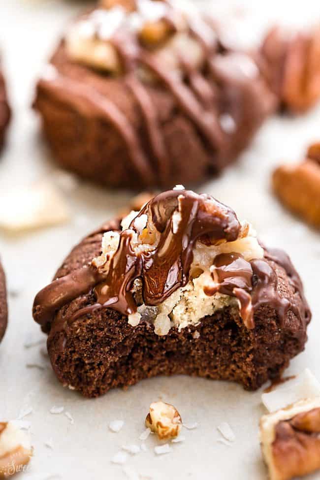 German Chocolate Thumbprint Cookies are all of the things you love about German Chocolate Cake in a cute little thumbprint cookie! A rich, chocolate shortbread with a coconut pecan frosting and drizzled in chocolate! 