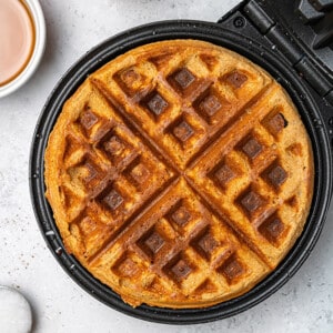 Top view of a one large Gluten Free Pumpkin Waffles on a waffle iron.