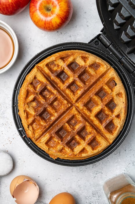 Top view of a one large Gluten Free Pumpkin Waffles on a waffle iron.