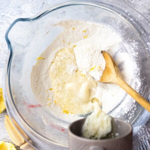 Top shot of ingredients for lemon gluten free donut batter in a clear bowl