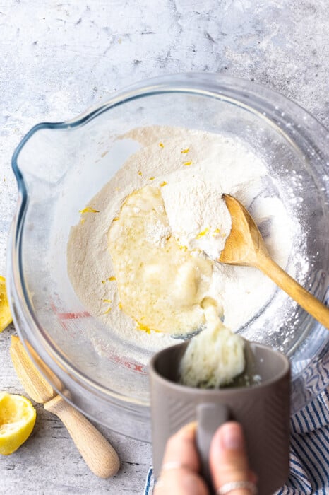 Top shot of ingredients for lemon gluten free donut batter in a clear bowl