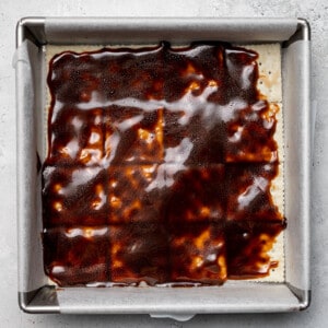 Melted toffee over crackers in a square baking pan