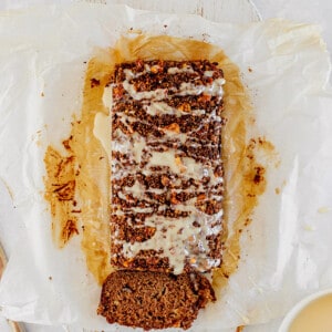 Far top view of a glazed apple bread on parchment paper