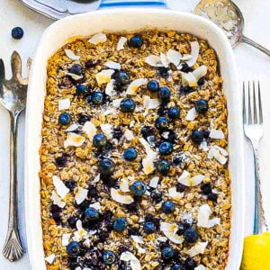 A blueberry oatmeal casserole inside of a large baking dish with handles
