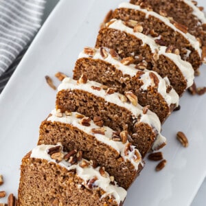 Top view of 7 slices of gluten free gingerbread loaf cake on a white plate