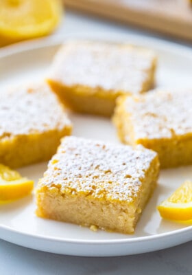 Side view of healthy lemon bars on a white plate