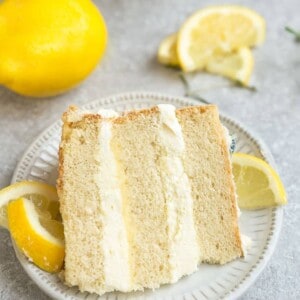 Close-up view of one slice of gluten free lemon cake on a white plate