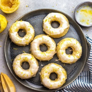 Top shot of six healthy lemon donuts on a grey plate