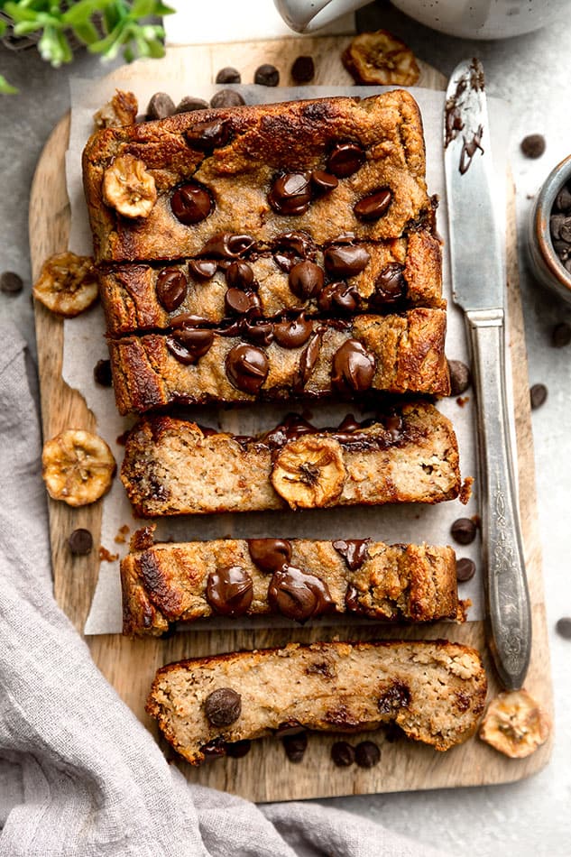 overhead image of paleo banana bread with chocolate chips and butter knife. 