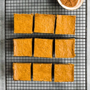 Top view of 9 healthy pumpkin bars son a black wire rack