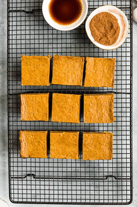 Top view of 9 healthy pumpkin bars son a black wire rack