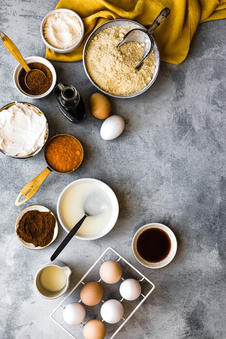 Top view of ingredients to make healthy pumpkin pie bars on a grey background