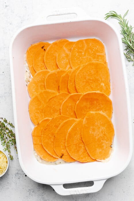 Sliced sweet potatoes in a baking dish