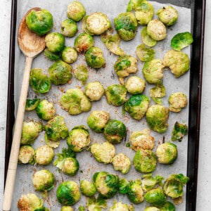 Top shot of a baking sheet lined with parchment paper with raw brussels sprouts