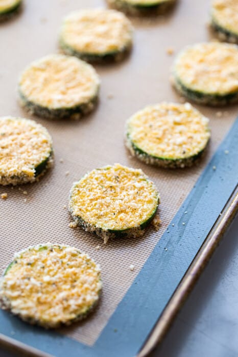 A baking sheet with unbaked zucchini chips