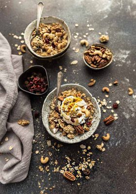 Coconut Cardamom Granola is the perfect easy grab and go breakfast or snack. Best of all, it's gluten free & full of crunchy clusters, nuts & warm spices.