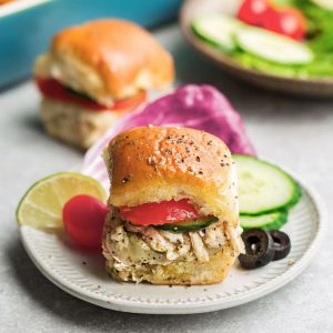 Greek Chicken Sliders - perfect easy appetizers for parties, game day and barbecues. Made with tender chicken, feta, gooey cheese and topped with cool and creamy Tzatziki sauce.
