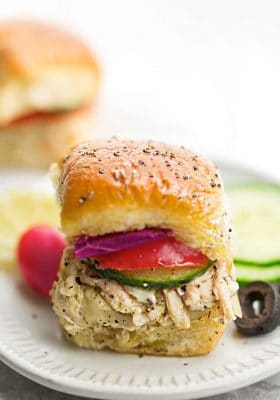 Greek Chicken Sliders - perfect easy appetizers for parties, game day and barbecues. Made with tender chicken, feta, gooey cheese and topped with cool and creamy Tzatziki sauce.