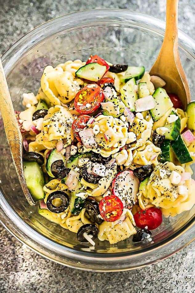 Top view of Greek Tortellini Pasta Salad in a glass bowl