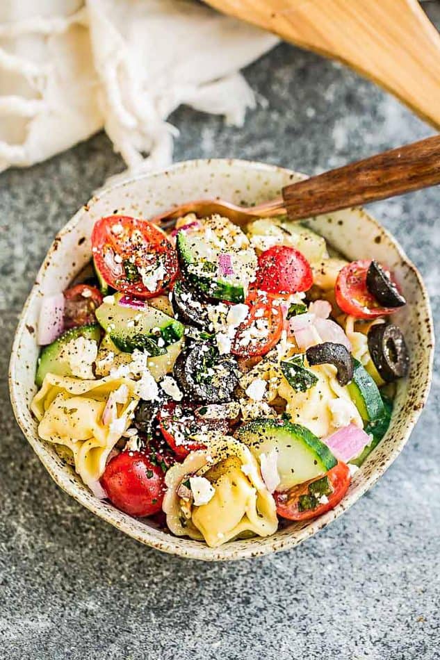 Top view of a serving of Greek Tortellini Salad in a bowl