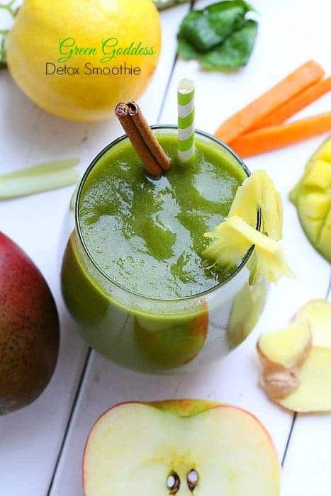 Overhead view of Green Goddess Detox Smoothie in a glass with a cinnamon stick and pineapple
