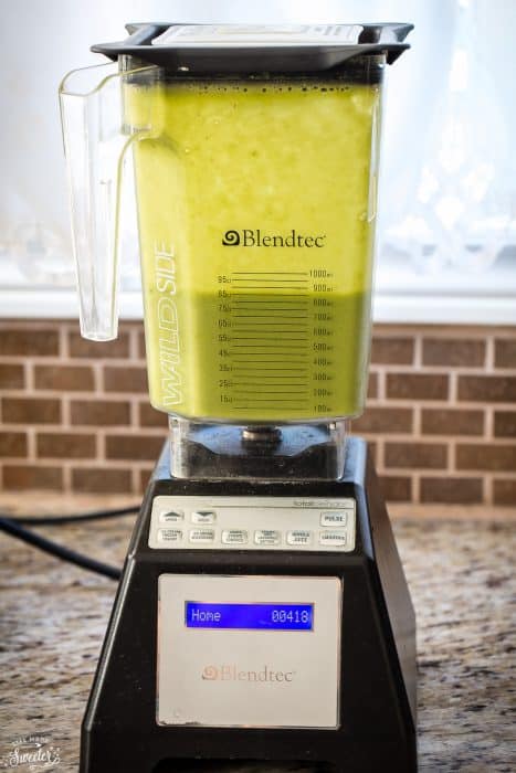 Side view of green smoothie in a blender