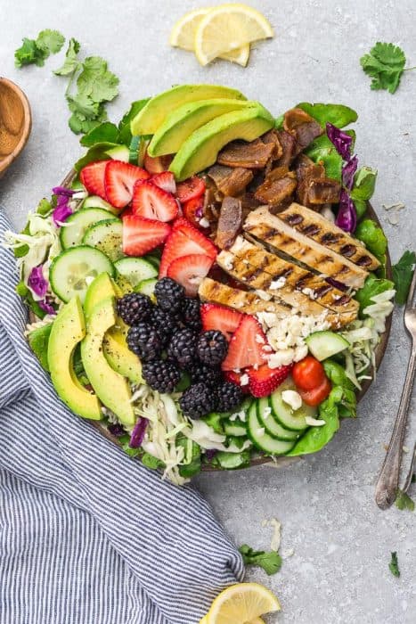 Summer Berry Grilled Chicken Salad - an easy and healthy lunch or dinner perfect for busy weeknights or summer potlucks. Made with avocado, cucumber, bacon, strawberries, blackberries and tomatoes with a tangy, fresh and flavorful lemon vinaigrette.