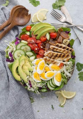 Chicken Cobb Salad has all the classic flavors of the popular favorite with a simple vinaigrette. Made with lettuce, tomatoes, bacon, cucumber, avocado and cheese – perfect for lunch or your next potluck!