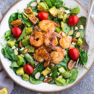 Grilled Shrimp Avocado Salad - a light and healthy & flavorful dish perfect for lunch or a light dinner. Made with spinach, avocado, cherry tomatoes, pecans, almonds and a homemade poppy-seed dressing. Low Carb, keto, paleo & Whole 30 compliant.