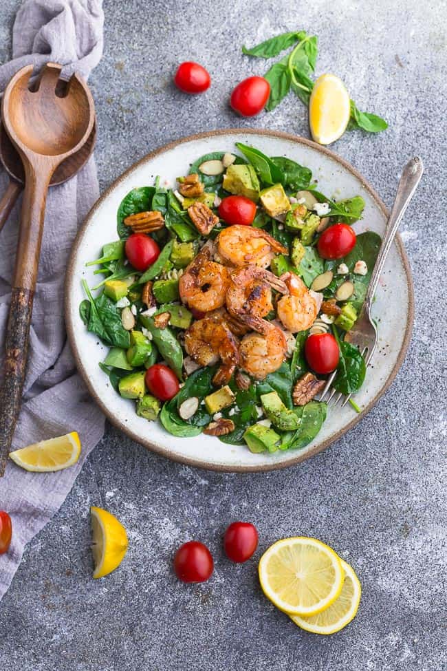 Grilled Shrimp Avocado Salad - a light and healthy & flavorful dish perfect for lunch or a light dinner. Made with spinach, avocado, cherry tomatoes, pecans, almonds and a homemade poppy-seed dressing. Low Carb, keto, paleo & Whole 30 compliant.