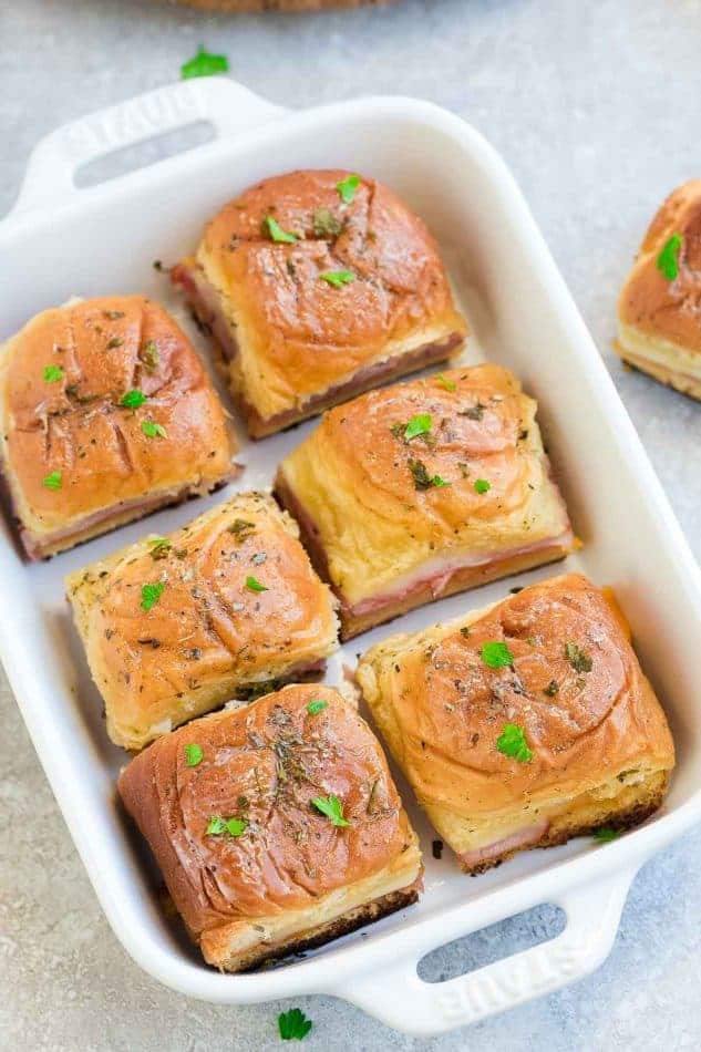 A Pan Full of Ham and Cheese Sliders on a Gray Countertop