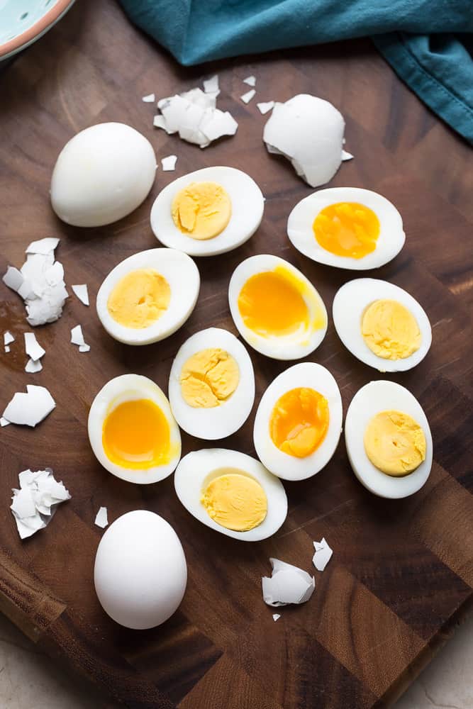 Top view of Halved Hard or Soft Boiled Eggs on a wooden board