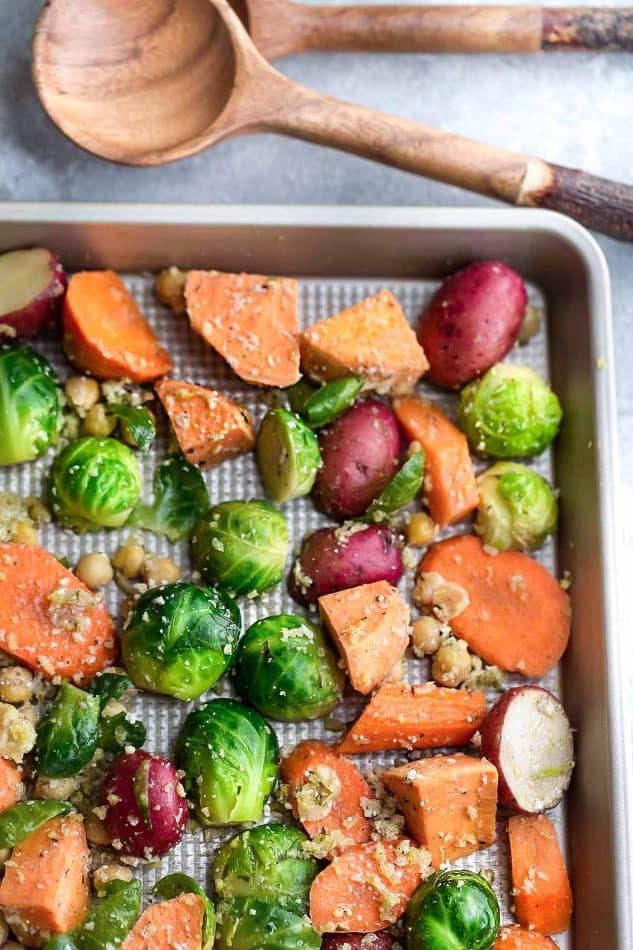 One Pan Roasted Harvest Vegetables - made with carrots, sweet potatoes, Brussels sprouts, baby potatoes and chickpeas. The perfect easy and delicious side dish for fall, Thanksgiving, Christmas or any busy weeknight meal! Best of all, so easy to customize and packed with crunchy panko crumbs and bursting with flavor from the Parmesan cheese, garlic and Italian seasoning.