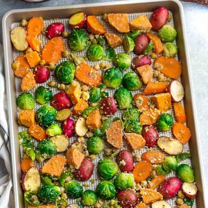 One Pan Roasted Harvest Vegetables - made with carrots, sweet potatoes, Brussels sprouts, baby potatoes and chickpeas. The perfect easy and delicious side dish for fall, Thanksgiving, Christmas or any busy weeknight meal! Best of all, so easy to customize and packed with crunchy panko crumbs and bursting with flavor from the Parmesan cheese, garlic and Italian seasoning.