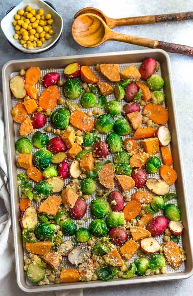 One Pan Roasted Harvest Vegetables - made with carrots, sweet potatoes, Brussels sprouts, baby potatoes and chickpeas. The perfect easy and delicious side dish for fall, Thanksgiving, Christmas or any busy weeknight meal! Best of all, so easy to customize and packed with crunchy panko crumbs and bursting with flavor from the Parmesan cheese, garlic and Italian seasoning.