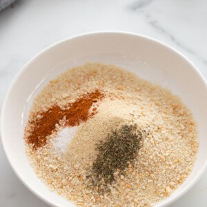 A white bowl of almond flour and seasonings for the cauliflower wing batter