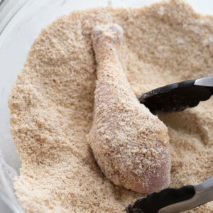 One chicken drumstick in flour coating