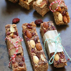 Homemade granola bars with almonds and cranberry, wrapped in paper