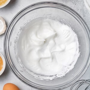 Overhead view of whipped egg whites in a bowl