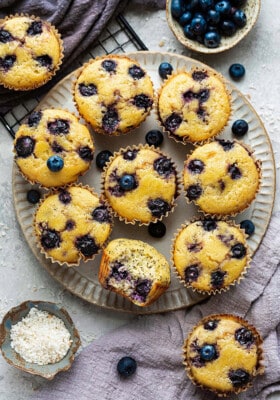 Overhead view of Lemon Blueberry muffins on a plate with a bite out of one