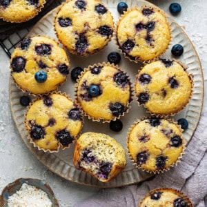 Overhead view of Lemon Blueberry muffins on a plate with a bite out of one