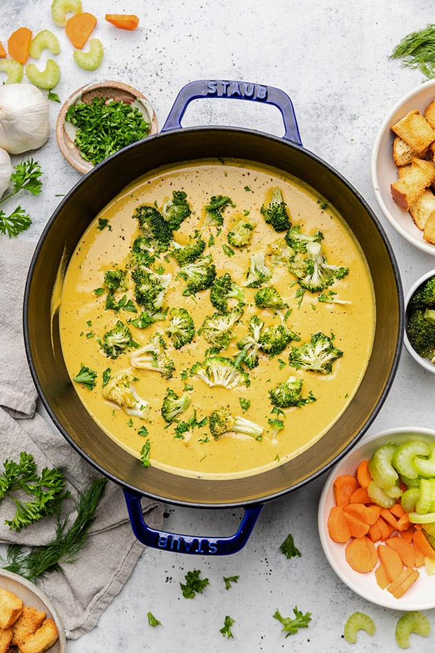 Broccoli cheddar soup in a blue dutch oven / pot