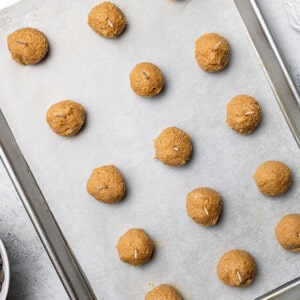 Overhead view of buckeye balls on a parchment-lined baking sheet