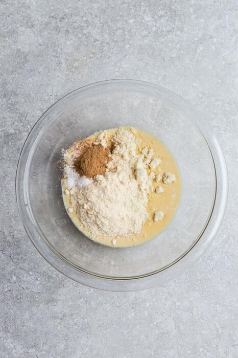 Almond flour, coconut flour, cinnamon, nutmeg, cloves and the rest of the dry ingredients inside of a large glass mixing bowl